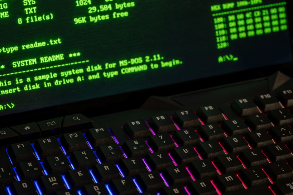 Close-up of a computer command line screen with a lit keyboard