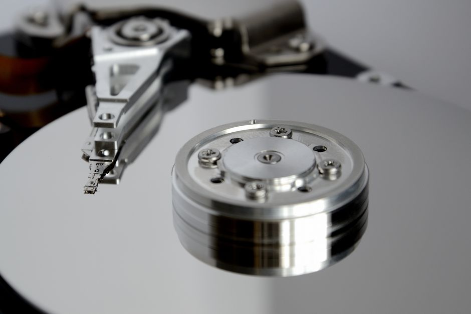 Close-up of an open hard drive showing its internal metallic components